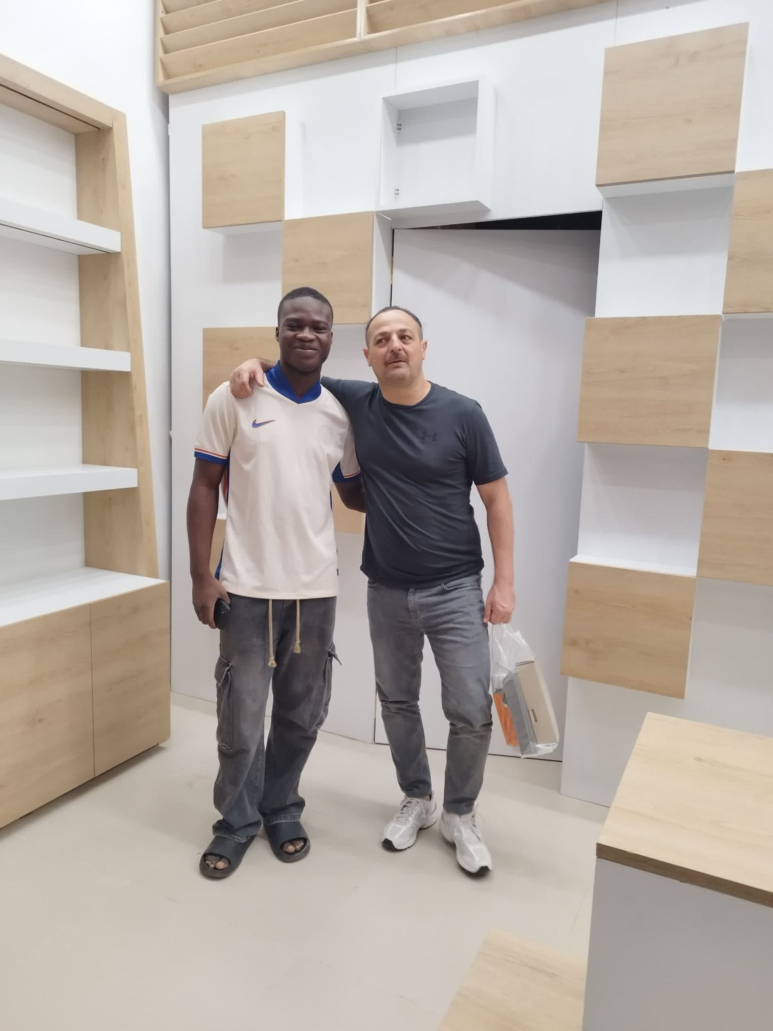 With Turkish client after night-shift mall store installation — Accra